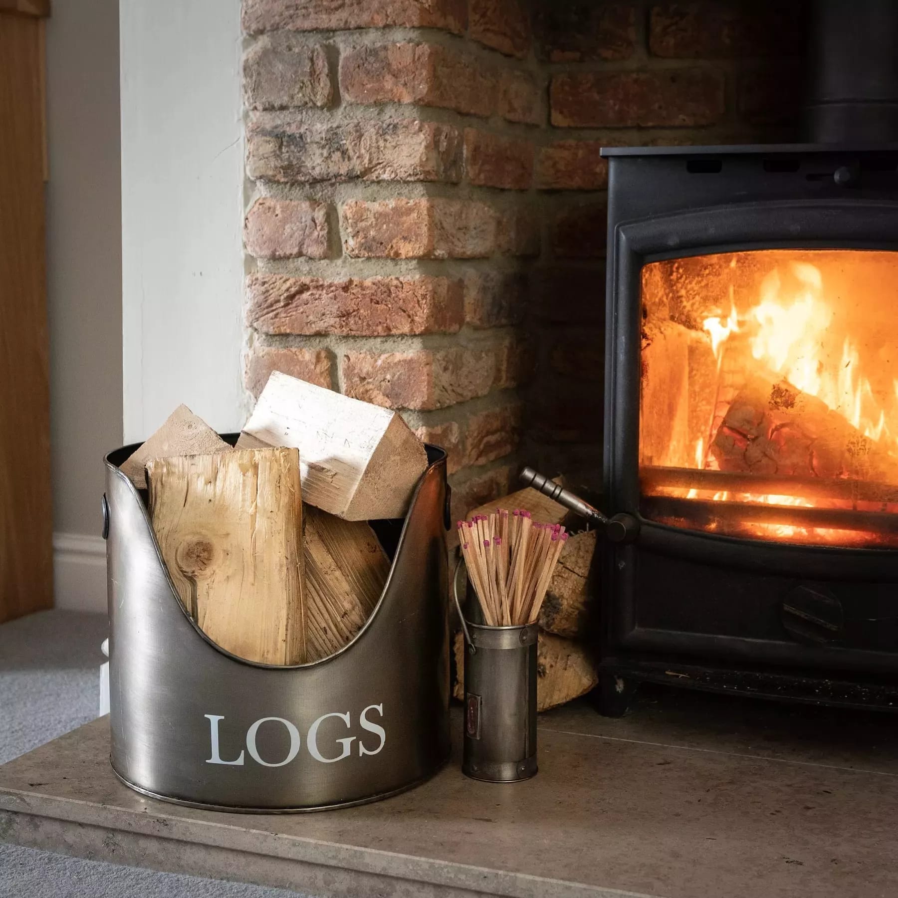 Greens Mill Interiors' premium collection of fireside accessories, featuring elegant and functional items like log baskets, fire tools, and hearth decorations to enhance your cozy home.